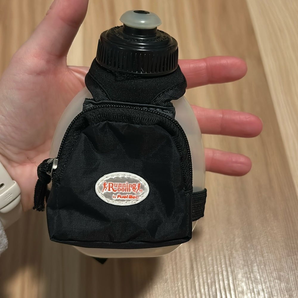 Hand held water bottle. 7oz bottle with hand strap incl small zipper pouch.